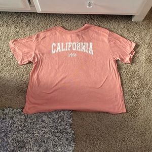 This is a coral/pink shirt with a white California font on the front.